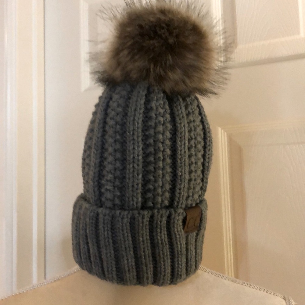 CC beanie, Dk Melange…with faux fur. Never worn. Smoke and pet free environment.